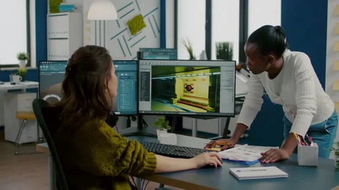 Mixed races of game creators testing the interface of videogame Stock Footage 152794160