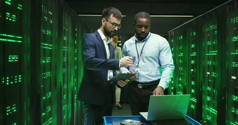 Mixed-races men checking program and tapping on tablet device. Software Video stock 137548118