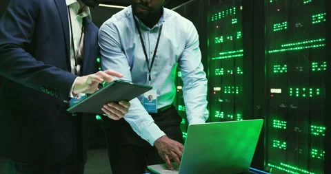 Mixed-races men checking program and working on tablet device and laptop Video stock 137548354