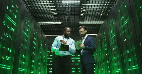 Mixed-races men with tablets devices. Software cryptographers walking at servers Stock Footage 137545942