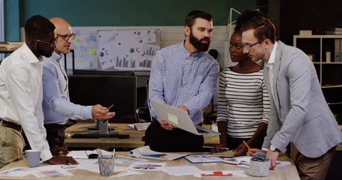 Mixed races office team discussing business project of startup and their young Stock Footage 82444688