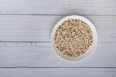 Mixed raw quinoa in bowl on white wooden kitchen table. top view. Healthy and Stock Photos