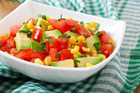 Mixed salad with avocado, tomatoes and sweet corn Stock Photos