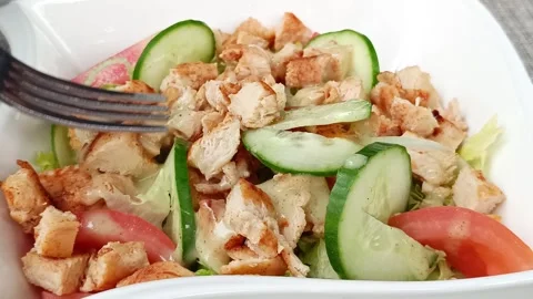 Mixed salad with chicken and raw vegetables, close-up Stock Footage 295055206