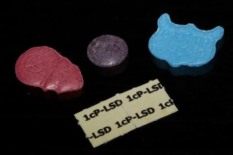 A mixed set of drugs and medicines pills containing mdma and lsd stick pape.. Stock Photos
