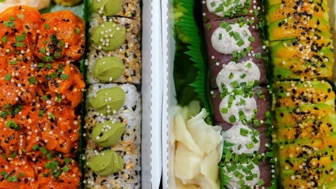 Mixed Set of Various Maki Sushi with Salmon, Tuna Fish Topped with Sauce, Cheese Stock Footage 233213835