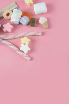 Mixed shape marshmallows on pink background Stock Photos