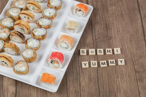 Mixed sushi set on a white ceramic board Stock Photos