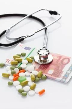 MIxed tablets with bundle of 10 euro note and stethoscope Stock Photos