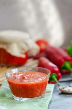 Mixed tomatoes and chilli sauce in bowl on table. Stock Photos