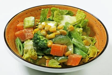 Mixed vegetable compound salad with broccoli, baby corn, cucumber carrot and Stock Photos