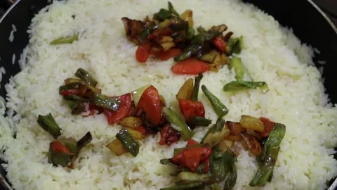 Mixed vegetables are mixed with fried biriyani rice in a pan video.4k. Stock Footage 278275449