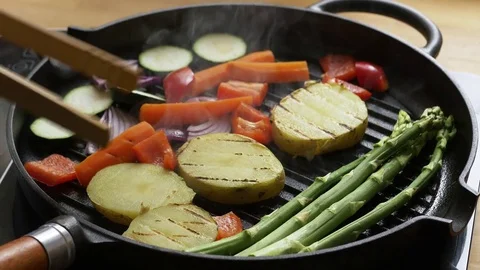 Mixed vegetables being grilled in a cast iron grill pan Stock Footage 76583545