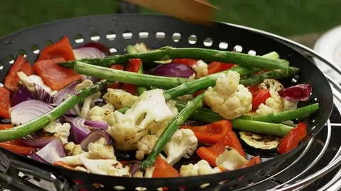 Mixed vegetables being grilled on a table grill Video stock 77165550