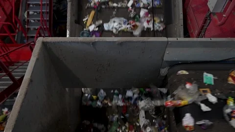 Mixed waste conveyed through central transport line in recycling facility Stock Footage 333345308