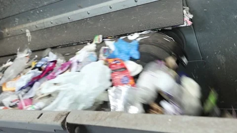 Mixed waste falling from conveyor belt in recycling plant Stock Footage 333345376