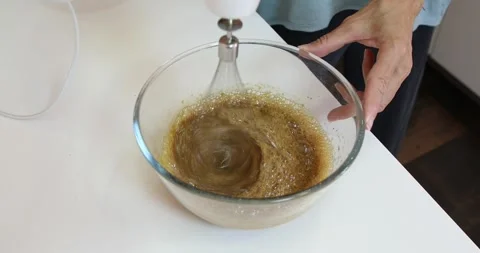 Mixer beating brown sugar with eggs Stock Footage 271023503