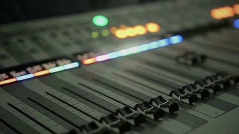 Mixer with lighting buttons, faders and adjusting knobs at music studio 動画素材 79123689