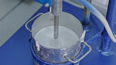 Mixer mixes the paint in the container Stock Footage 239859475