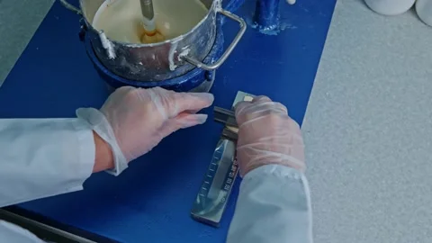 Mixer mixes the paint in the container Stock Footage 239859843