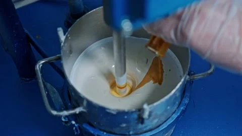 Mixer mixes the paint in the container Stock Footage 239859879