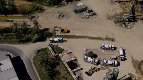Mixer trucks line up in queue to load fresh concrete in an active industrial Video stock 334560380