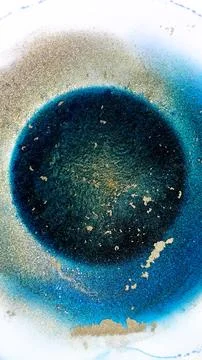 Mixing alcohol ink in a circle on a flat surface Stock Photos