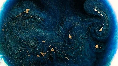 Mixing alcohol ink creates patterns and textures in a circular shape Stock Photos