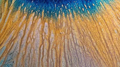 Mixing alcohol ink creates patterns in vibrant colors on a surface Stock Photos