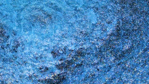Mixing alcohol ink in macro shot shows swirling patterns and textures Stock Footage 344724660
