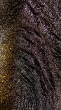 Mixing alcohol ink in macro view showing colorful fragments Stock Photos