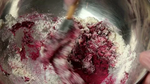 Mixing almond meal, powdered sugar and pink jam for making French Macaroons Stock Footage 62425761