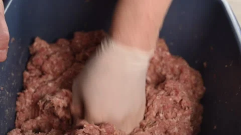 Mixing and preparing minced meat for filling the sausage Stock Footage 233728677