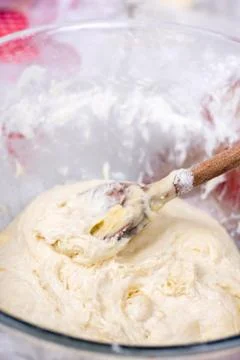 Mixing and preparing pizza or bread dough with wooden utensil Stock Photos