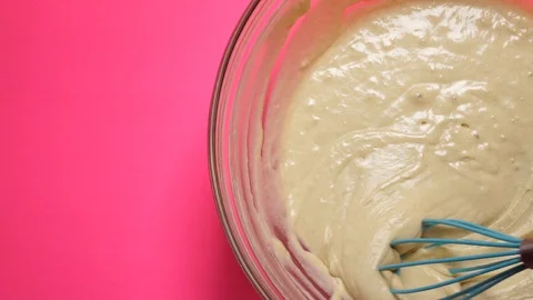 Mixing Batter Overhead with a bold pink backdrop Stock Footage