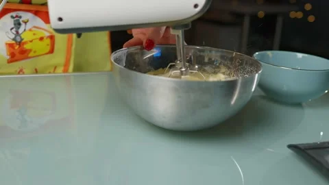 Mixing the batter thoroughly using an electric beater Stock Footage 295759924