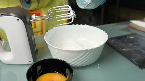 Mixing the batter thoroughly using an electric beater Vidéo 295761695