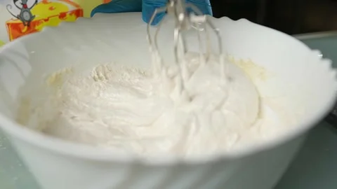 Mixing the batter thoroughly using an electric beater Vidéo 295761831