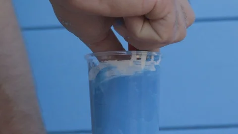 Mixing Blu Paint with Brush Video stock 89770335