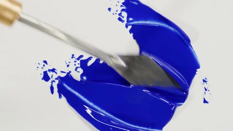 Mixing blue paint close-up. Drawing on white paper top view. Smearing guache Stock Footage 178614612