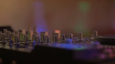 Mixing board knobs or DJ controller CU with colored lights - dolly shot Stock Footage 72080886