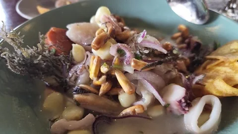 Mixing up a bowl of Peruvian ceviche  Video stock 308358758