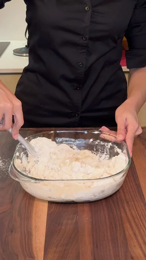 Mixing Bread Dough Ingredients with Silicone Spatula in Glass Bowl Stock Footage 330676842