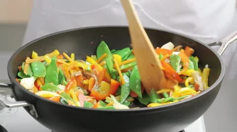 Mixing broccoli with other vegetables in a wok Stock Footage 24665129