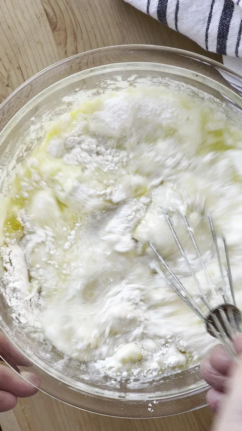 Mixing cake batter with a whisk Stock Footage 235629406