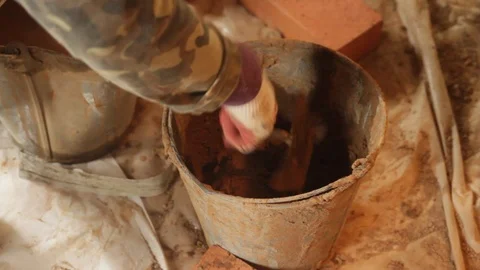 Mixing cement in a bucket Stock Footage 97226812