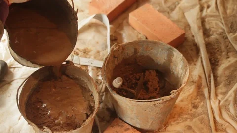 Mixing cement in a buckets Stock Footage 97243387