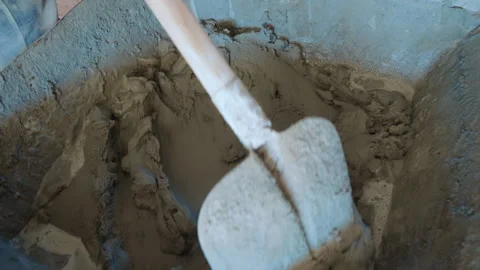 Mixing Cement for Construction Project, Close-up of cement being mixed in a Stock Footage 281182175