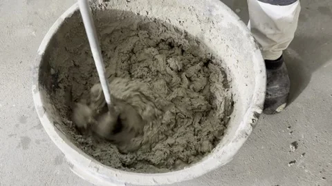 Mixing cement mortar or adhesive in a bucket - close up Stock Footage 335152107
