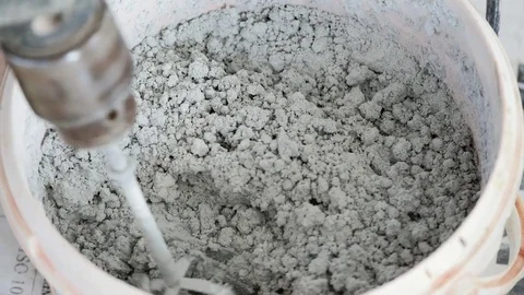 Mixing cement for the preparation of Construction Stock Footage 82535654